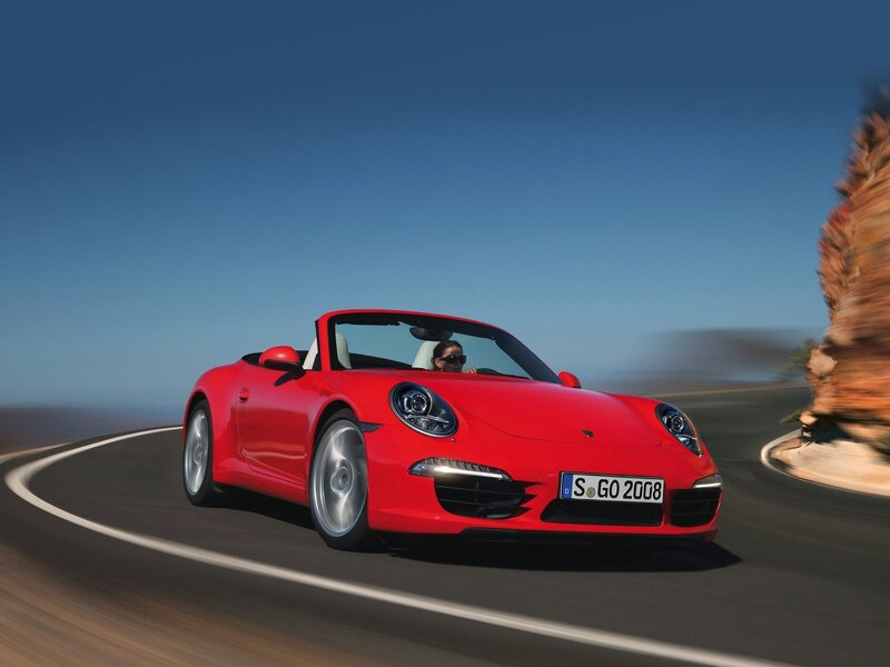 Red Porsche convertible on road
