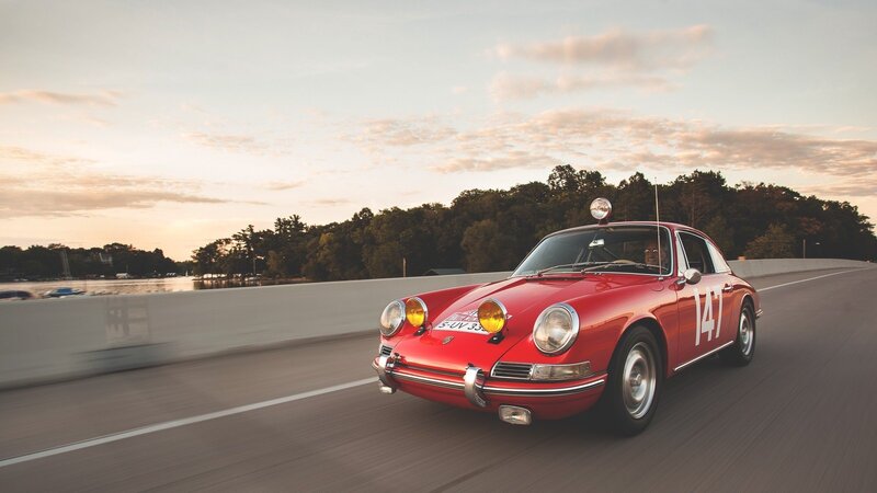 Red Porsche on a scenic road