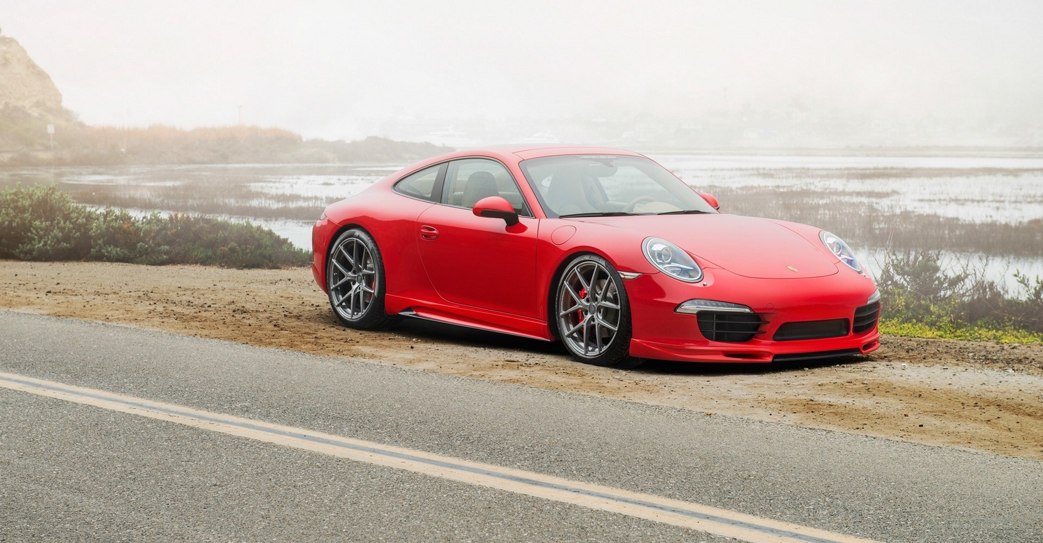 Red Porsche on coastal road