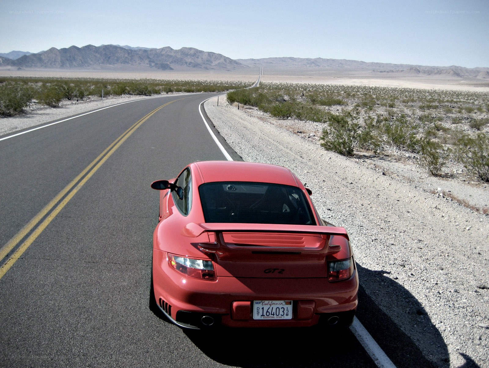 Red Porsche on desert road