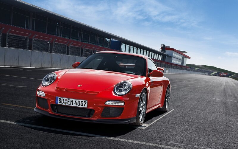 Red Porsche on Racetrack — Dramatic, Afternoon, Photograph, Building