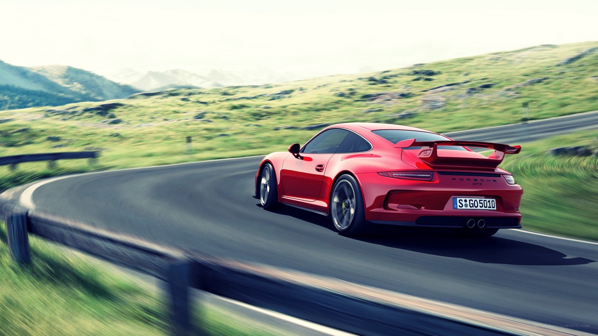 Red Porsche on winding road
