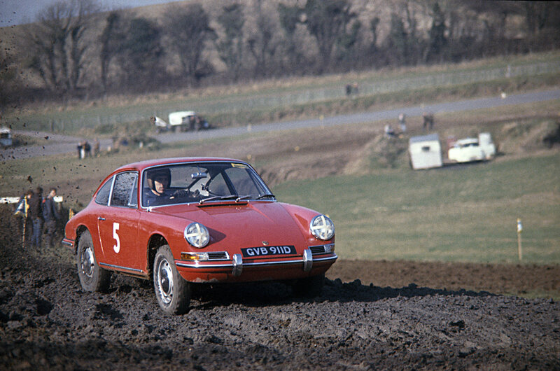 Red Porsche racing on dirt