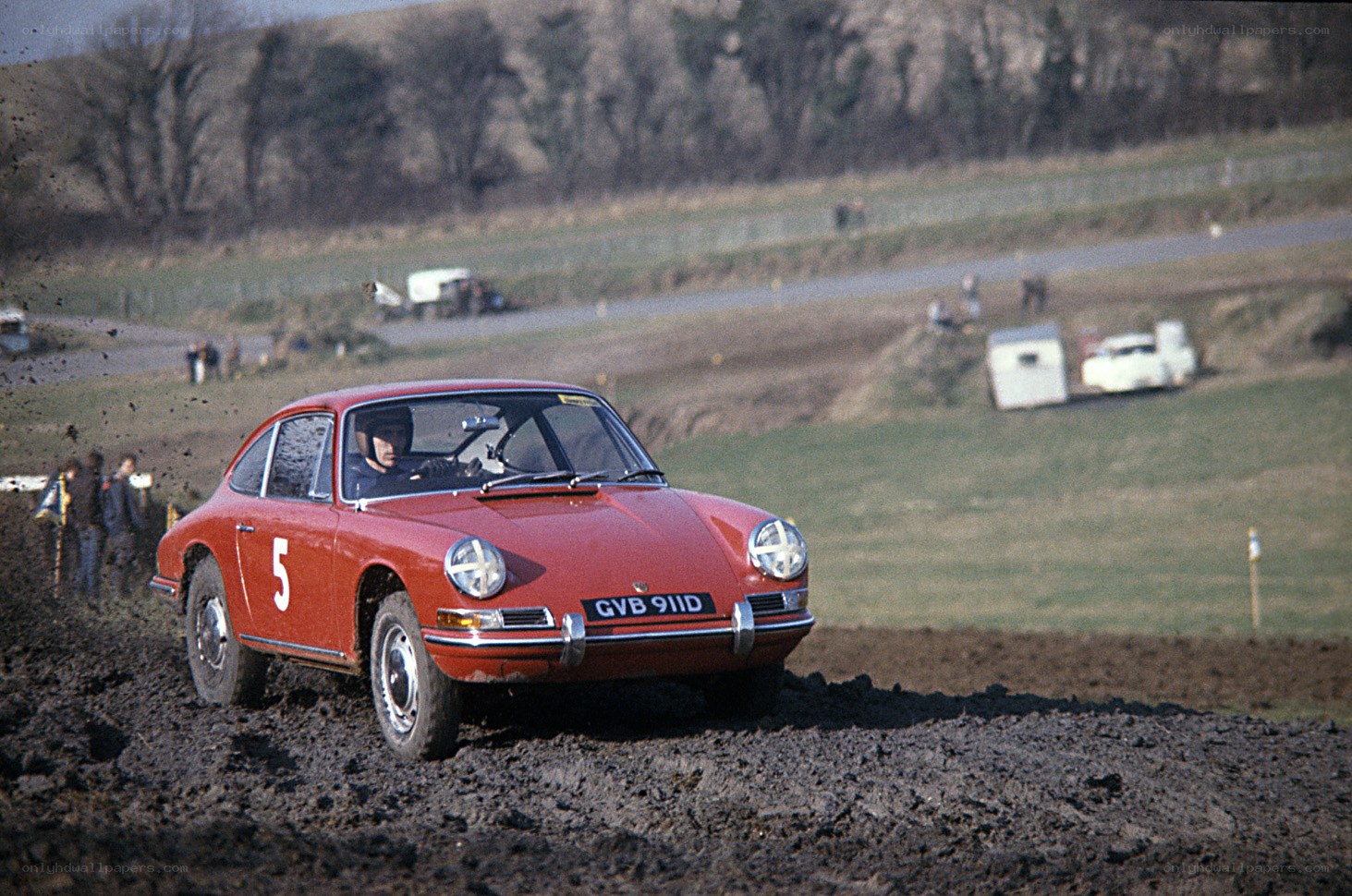 Red Porsche racing on dirt