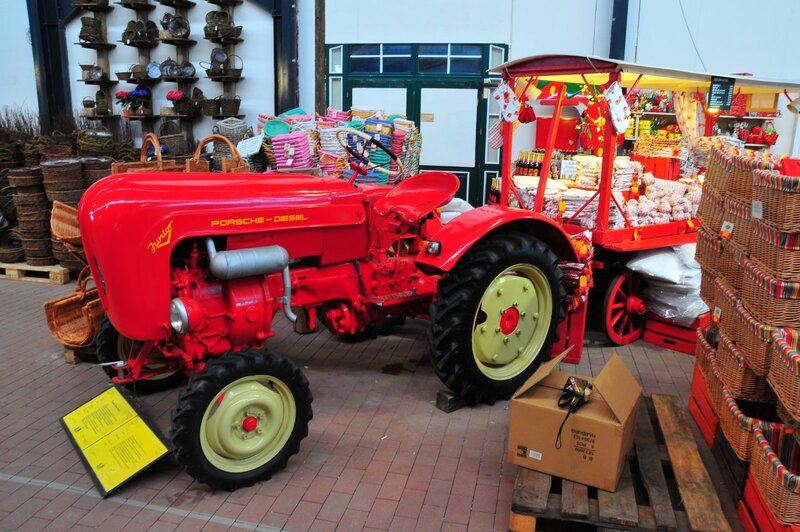 Red Porsche tractor at market