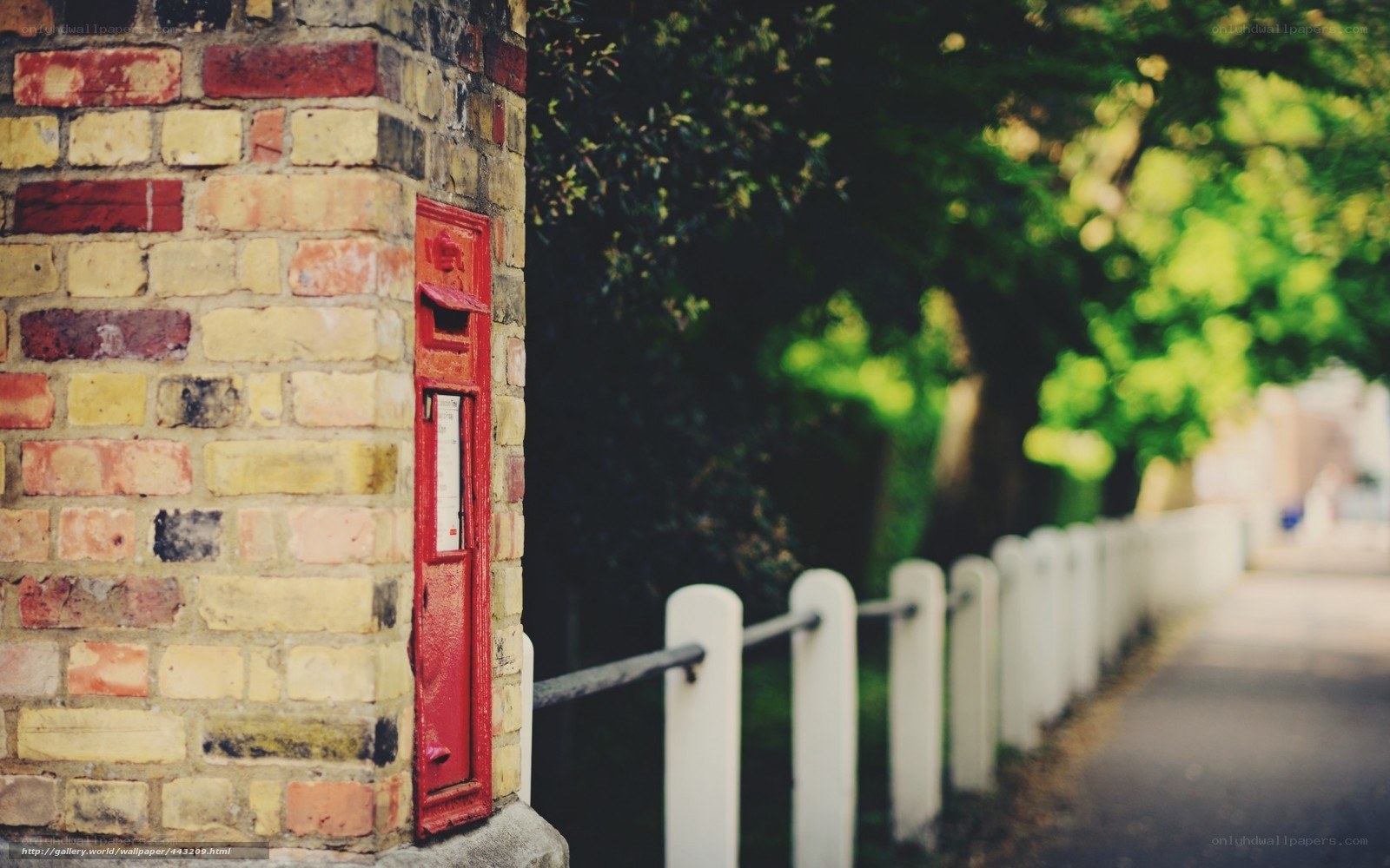 Red post box on brick wall