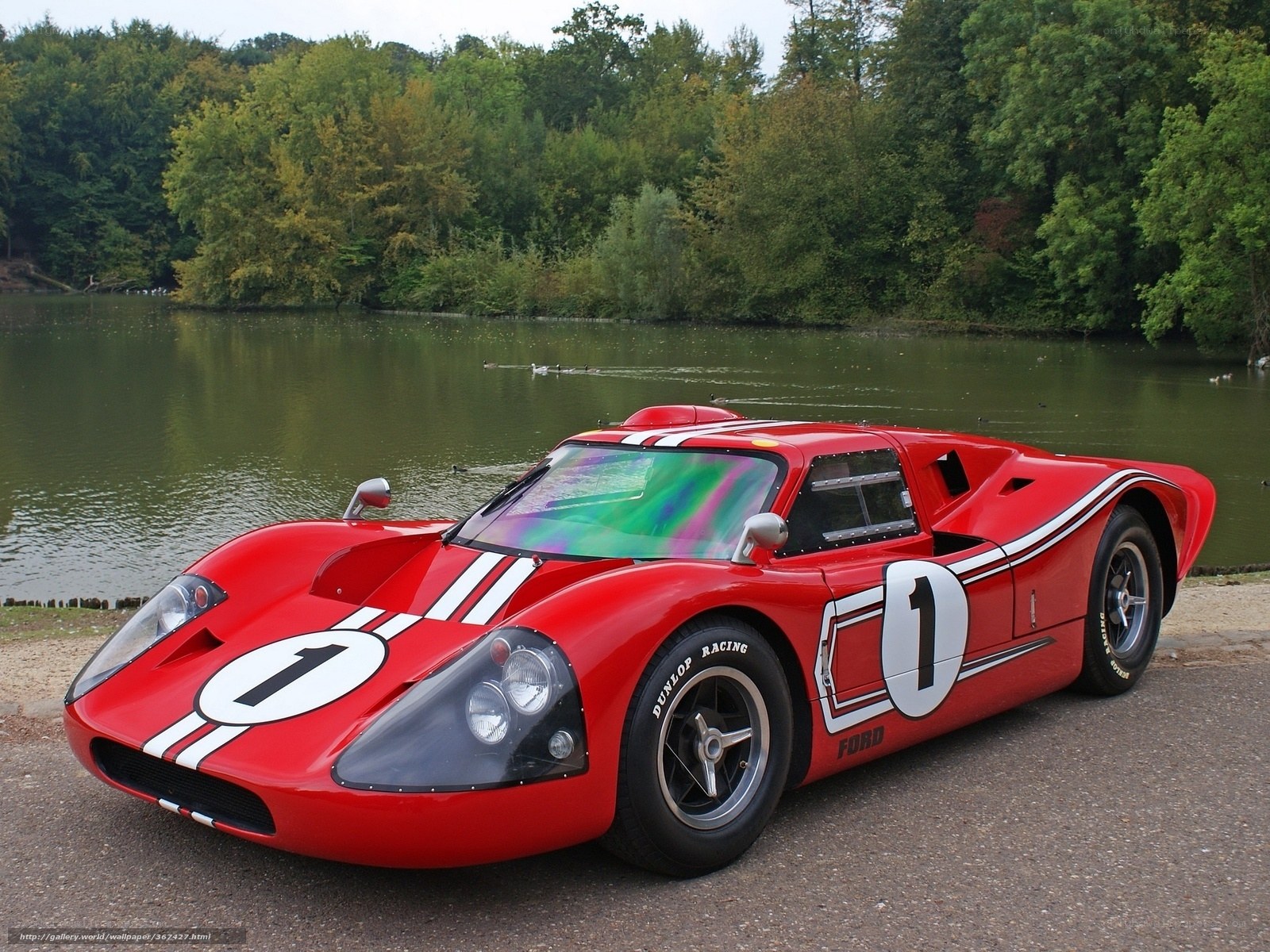 Red race car by a lake