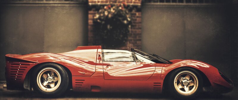 Red Race Car — Dramatic, Photograph, Brick Wall