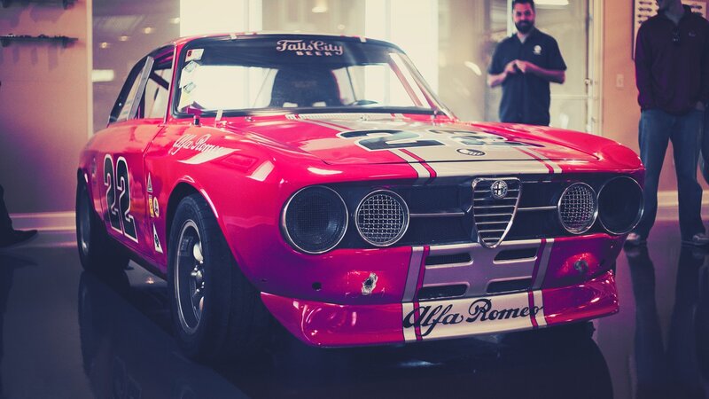 Red Race Car — Dramatic, Photograph, People, Building