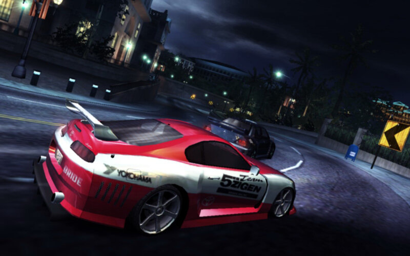 Red race car drifting at night