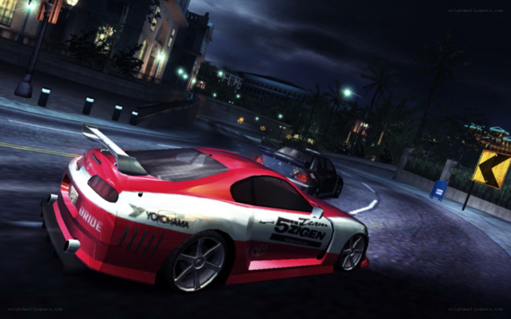 Red race car drifting at night