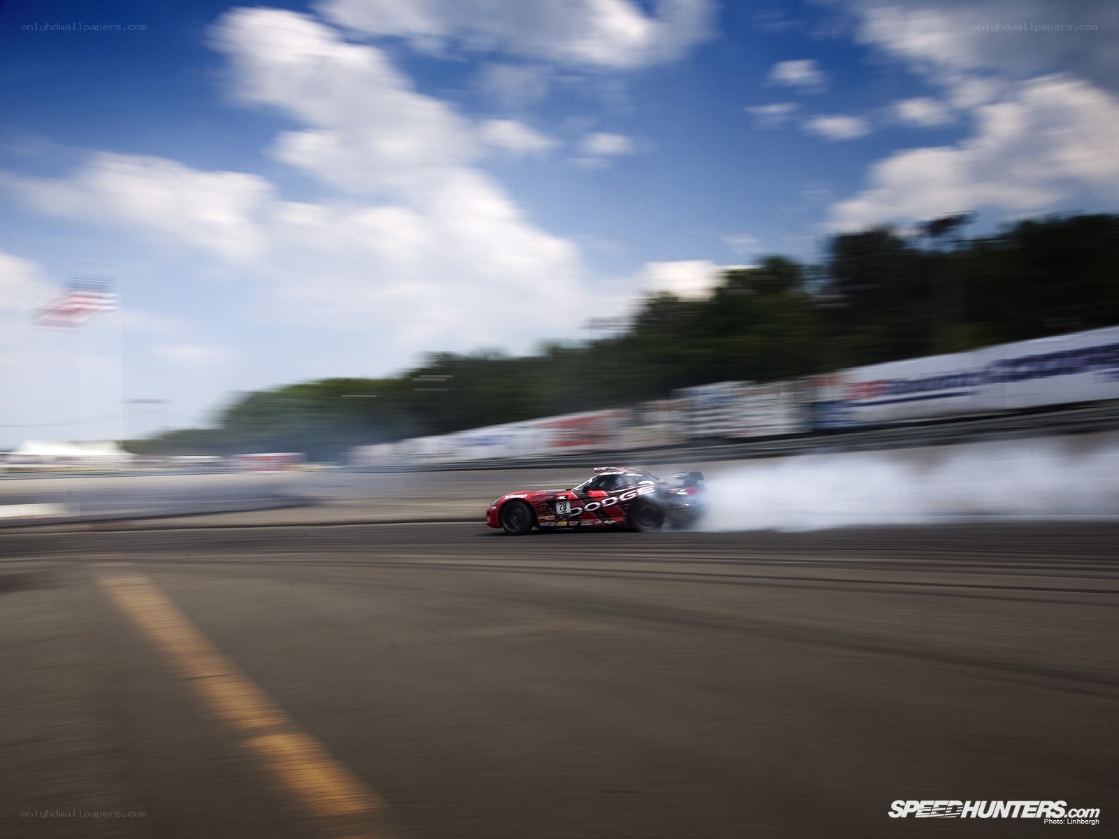 Red race car drifting on track