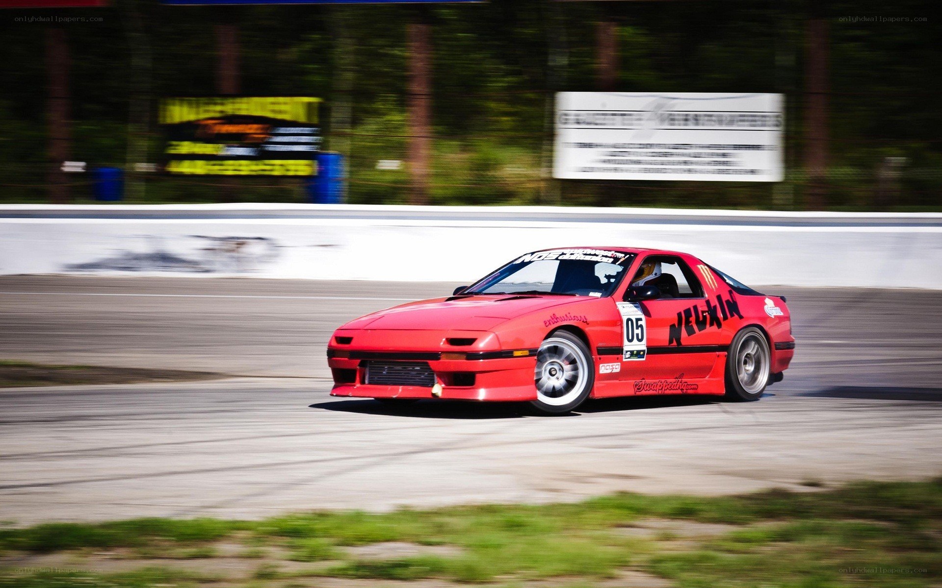 Red race car drifting on track