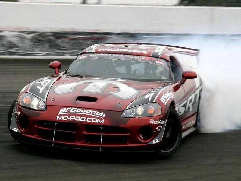 Red race car drifting on track