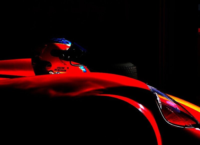 Red race car in dark garage