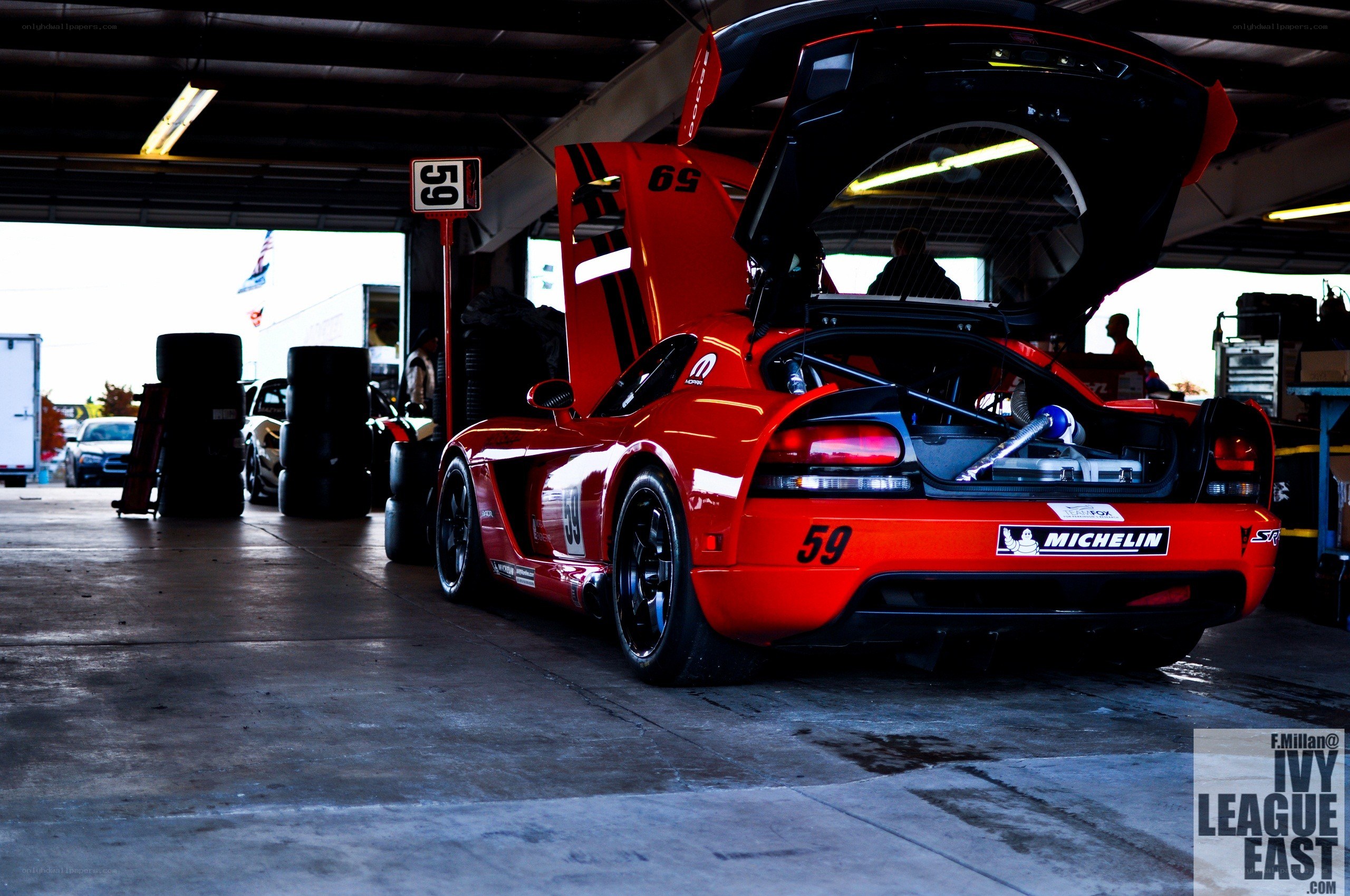Red race car in pit garage