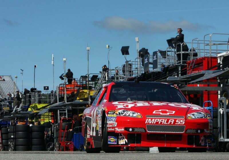 Red race car in pit lane