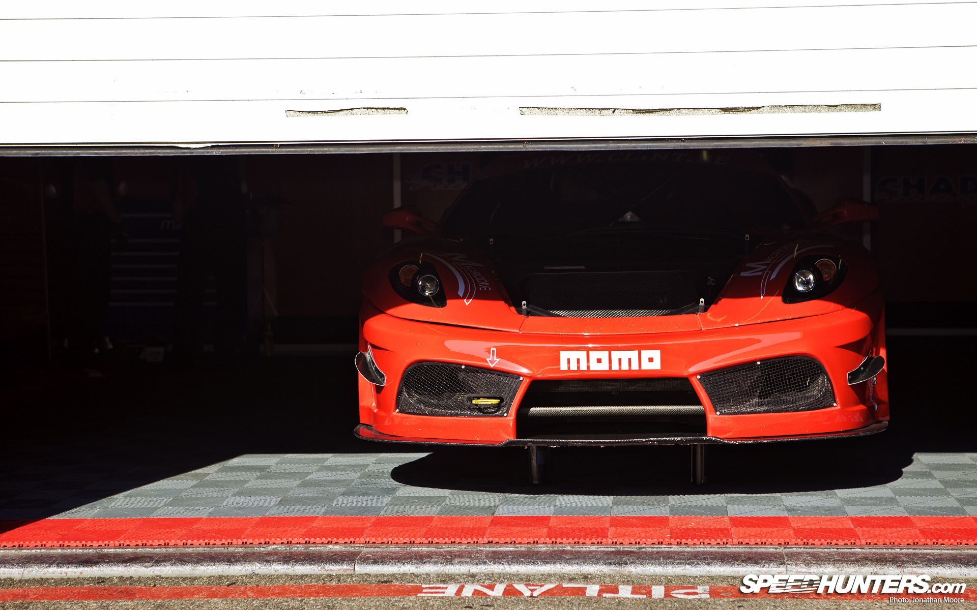 Red race car in pit lane