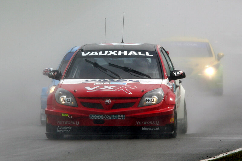 Red race car on a wet track