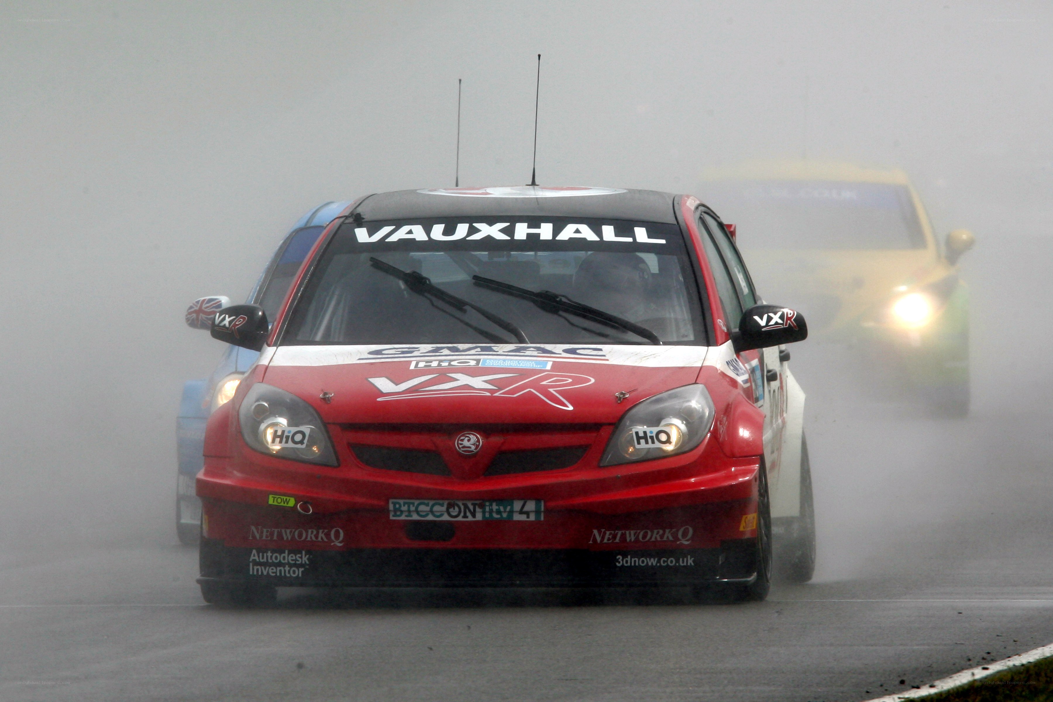 Red race car on a wet track