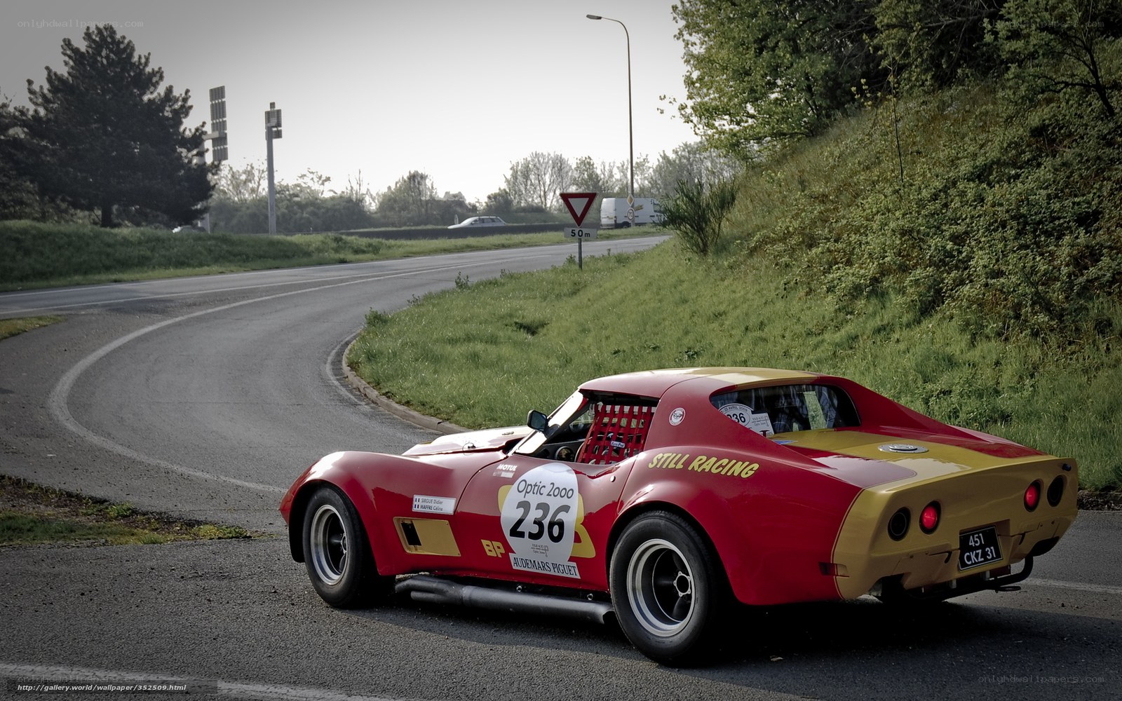 Red race car on a winding road