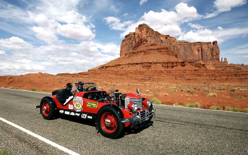 Red race car on desert road