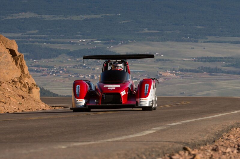 Red race car on mountain road