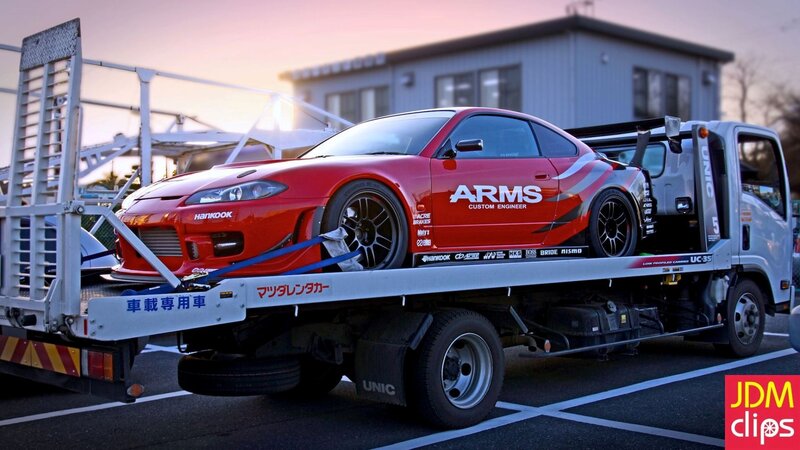 Red race car on tow truck
