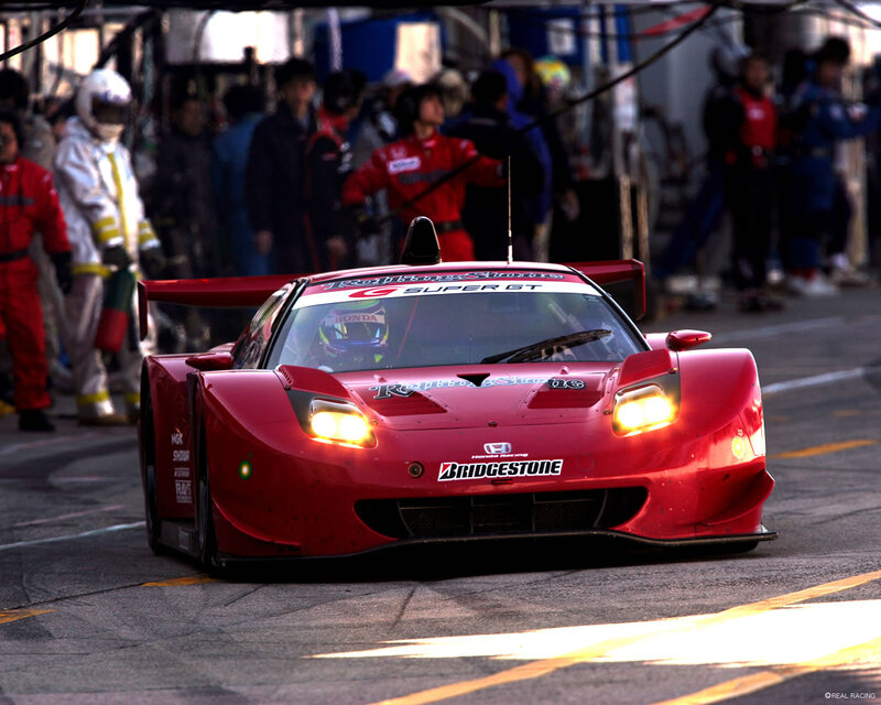 Red race car on track