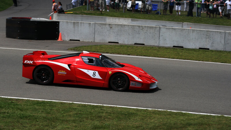 Red Race Car on Track — Active, Afternoon, Photograph, Race Car, Spectators