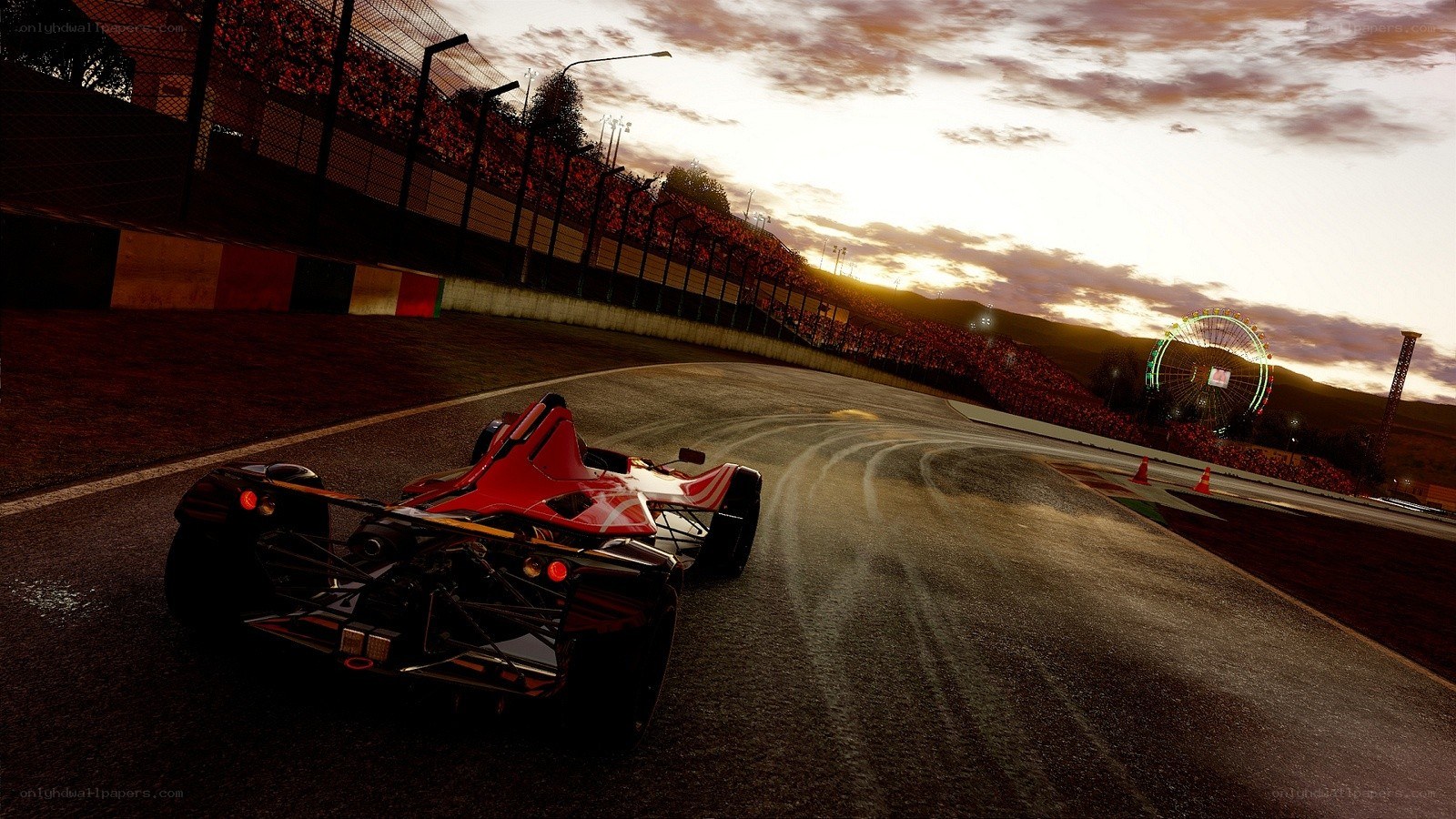Red race car on track at sunset