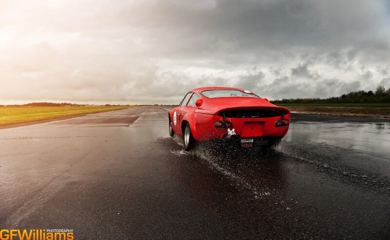 Red Race Car on Track — Dramatic, Afternoon, Photograph, Wet Road