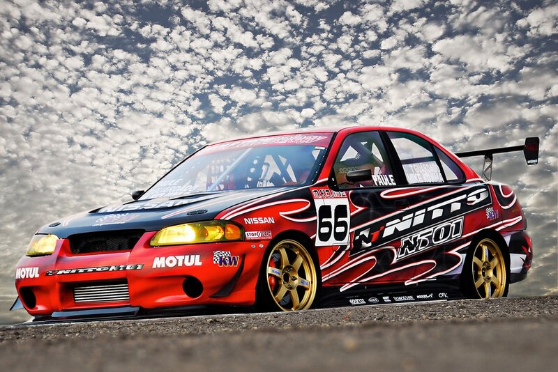 Red Race Car on Track — Dramatic, Photograph, Sky