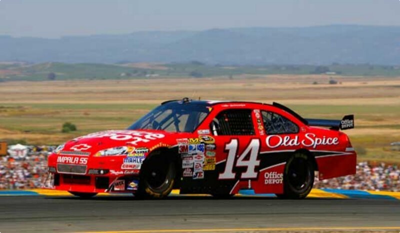 Red Race Car on Track — Dynamic, Afternoon, Photograph, Crowd, Mountains