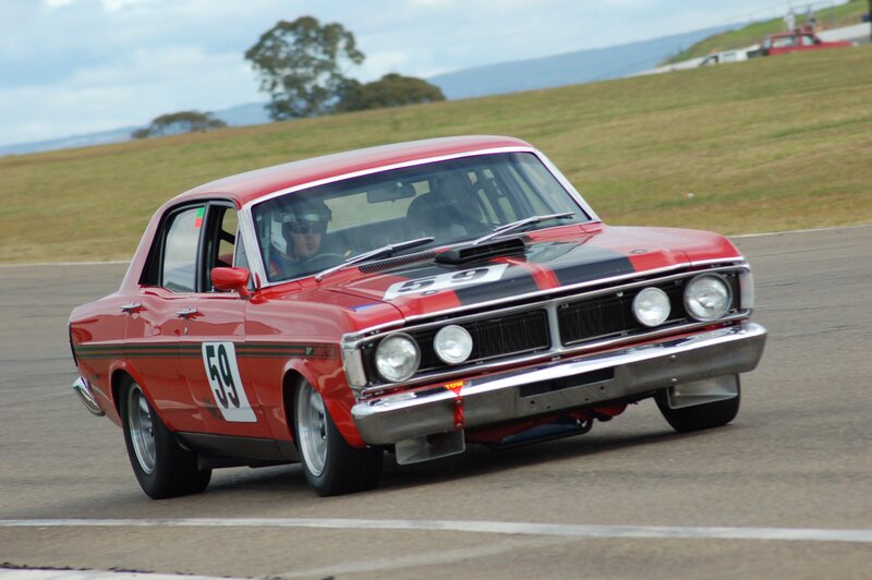 Red Race Car on Track — Dynamic, Afternoon, Photograph, Driver, Race Track, Grass Field