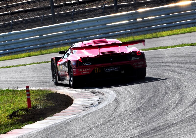 Red Race Car on Track — Dynamic, Afternoon, Photograph, Race Car, Guardrail