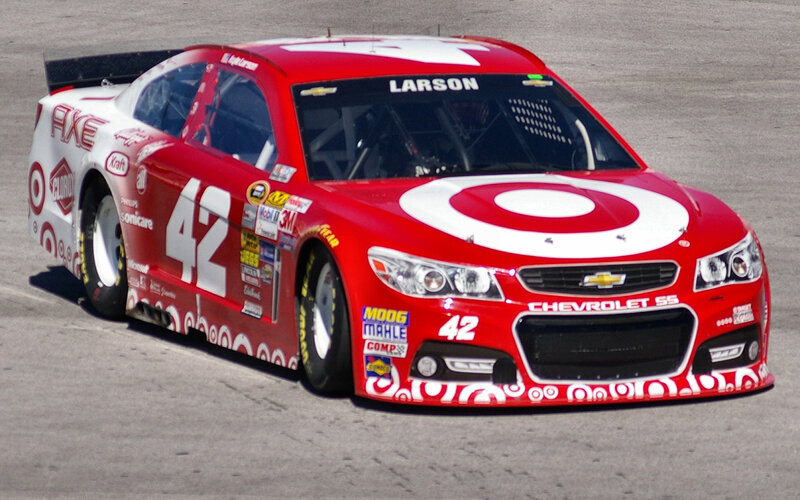 Red Race Car on Track — Dynamic, Afternoon, Photograph, Race Car, Target Logo