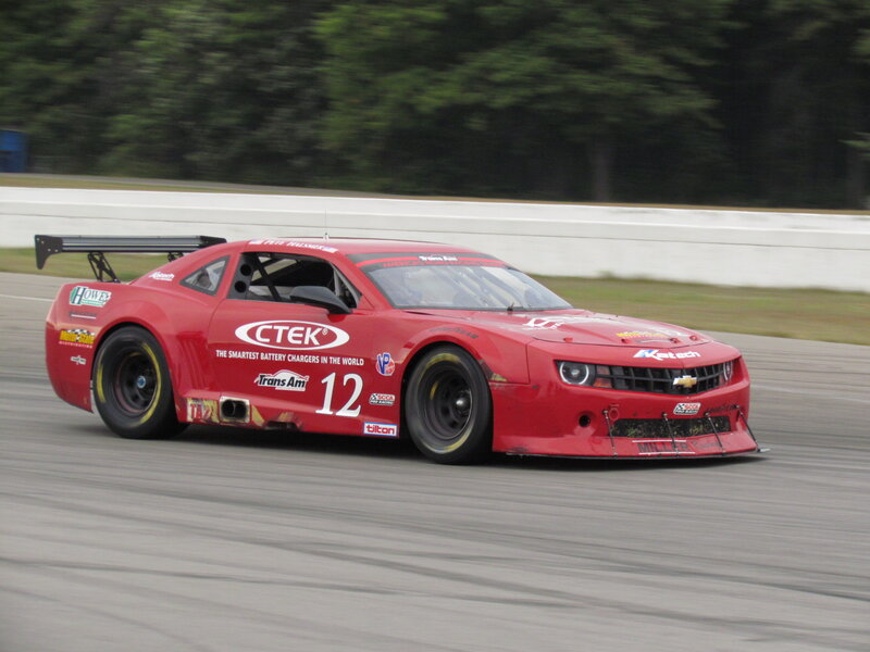 Red Race Car on Track — Dynamic, Afternoon, Photograph, Race Car, Trees