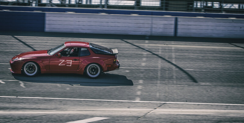 Red Race Car on Track — Dynamic, Afternoon, Photograph, Race Track, Driver, Wall