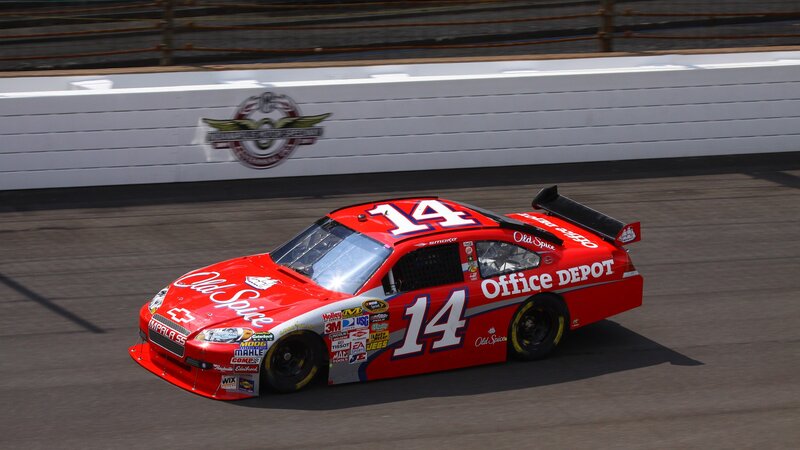 Red Race Car on Track — Dynamic, Afternoon, Photograph, Race Track, Wall