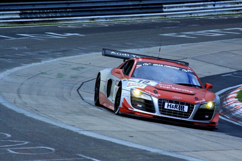 Red Race Car on Track — Dynamic, Night, Photograph, Race Car, Guardrail