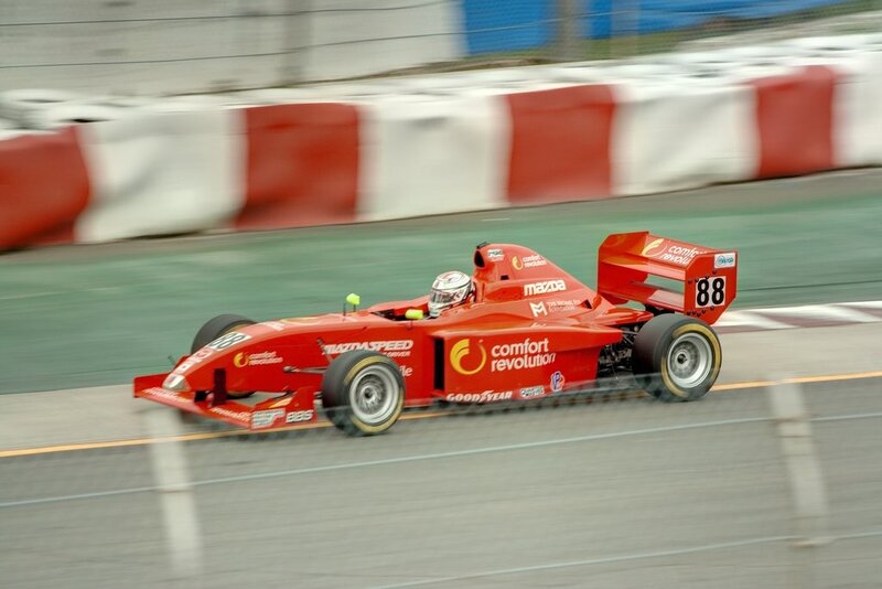 Red Race Car on Track — Dynamic, Photograph, Driver, Race Track, Safety Barrier