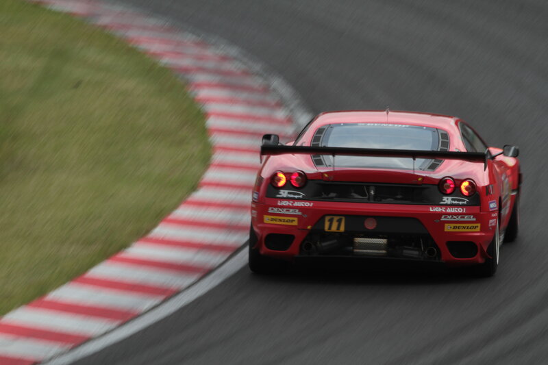 Red Race Car on Track — Dynamic, Photograph, Race Car, Grass, Black