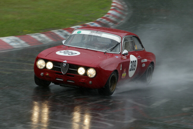 Red Race Car on Track — Dynamic, Photograph, Race Car, Wet Track