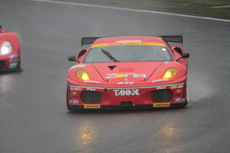 Red race car on wet track