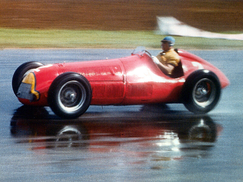 Red race car on wet track
