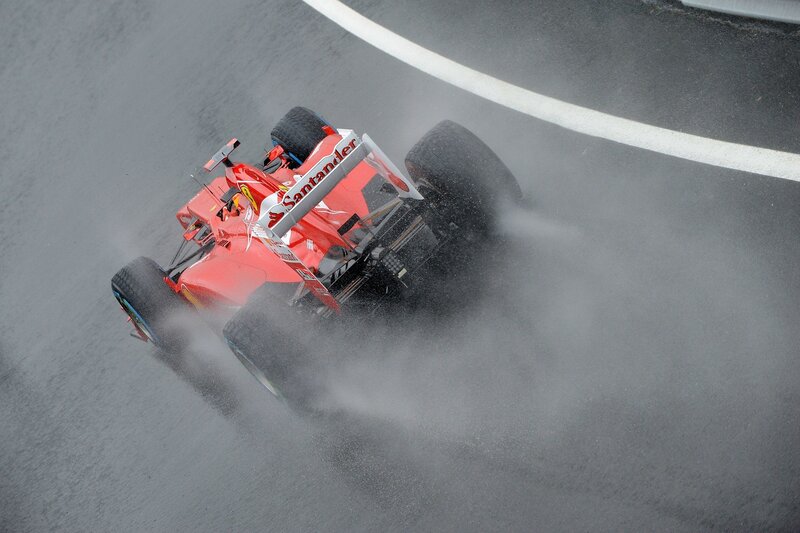 Red race car on wet track
