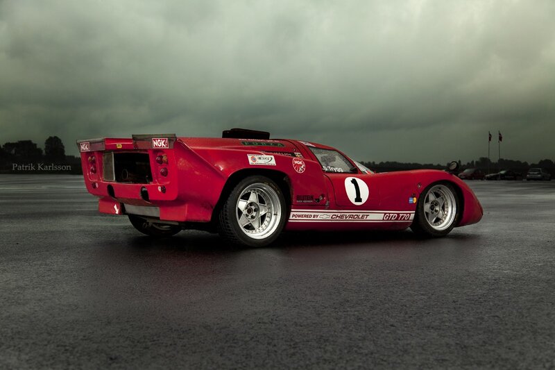 Red race car on wet track