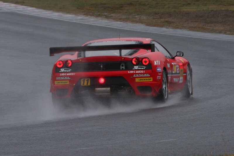 red race car on wet track