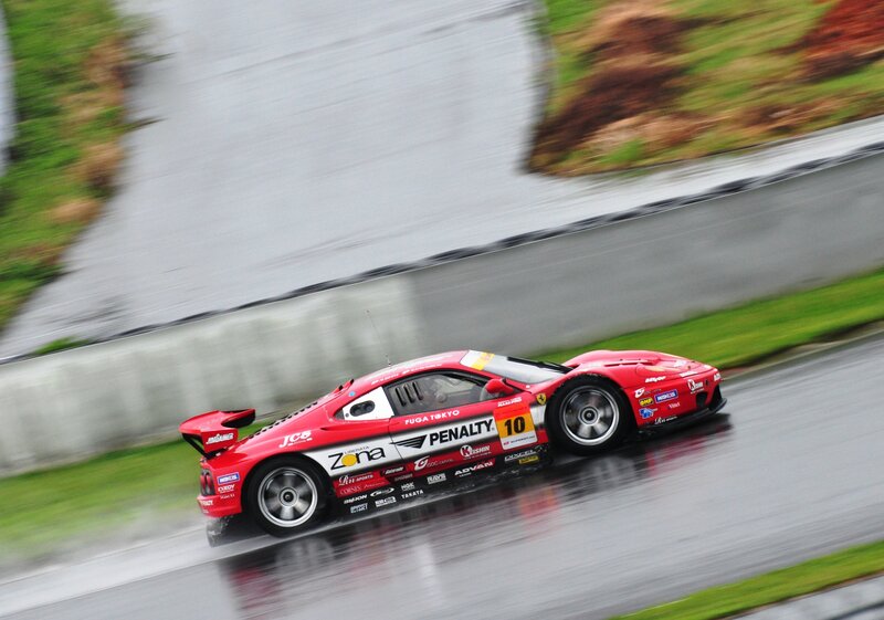 Red race car on wet track